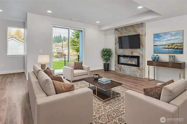 Large living space on main level with access to covered deck. Virtually staged.