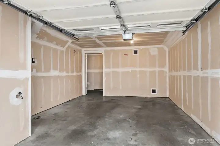 Abundant garage with extra storage room in back