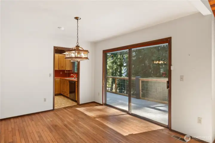 The dining room has hardwood floors and past the sliding glass window you see a peek-a-boo view of the bay.