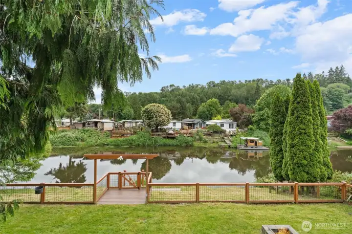 Step outside and take in breathtaking river view framed by established evergreens and lush vegetation — a serene backdrop that feels a world away from the city. The private gate riverfront access and level back lawn create the ideal setting for al fresco relaxation or effortless indoor-outdoor living.