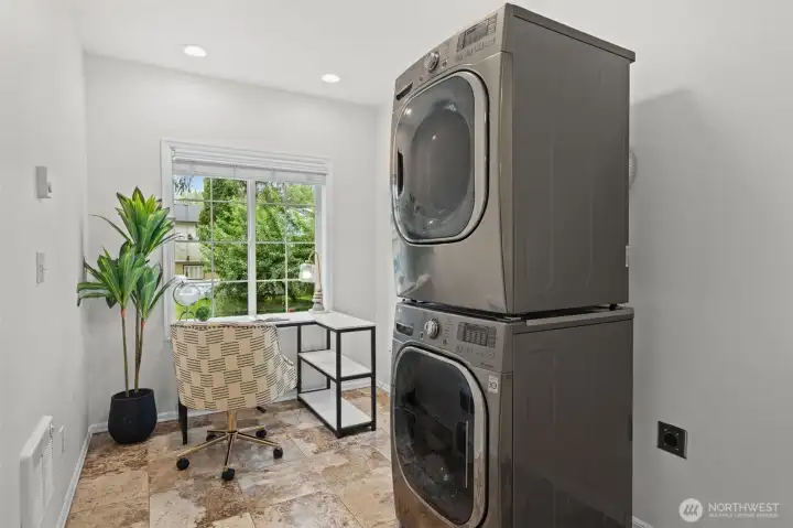 A stacked LG washer and dryer are tucked neatly into this flexible room. Great for a home office, or people watching as this is a walker's dream. Right off the Burke-Gilman trail so this room provides a great perch from which to watch the world go by. The stone tile flooring and generous footprint make this far more than just a laundry room