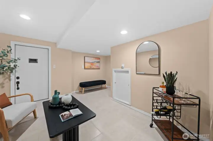 This versatile lower level bonus room is a blank canvas ready for your vision — a second living space, home gym, media room, or entertainment lounge. The tile flooring, recessed lighting, and  access door to storage room make it functional and flexible.