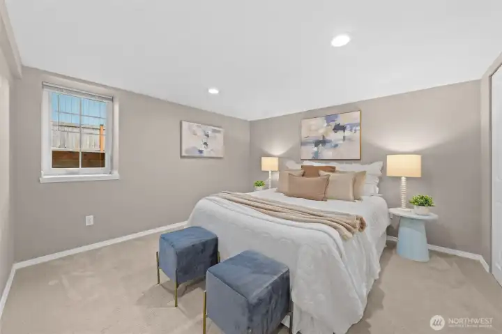 This comfortable lower-level bedroom is part of the fully self-containted, private ADU. It features recessed lighting, soft carpet, and a reach-in closet, making it ideal as a guest room, home office, or flex space. The calm, neutral tones and thoughtful layout give it a polished, move-in ready feel.