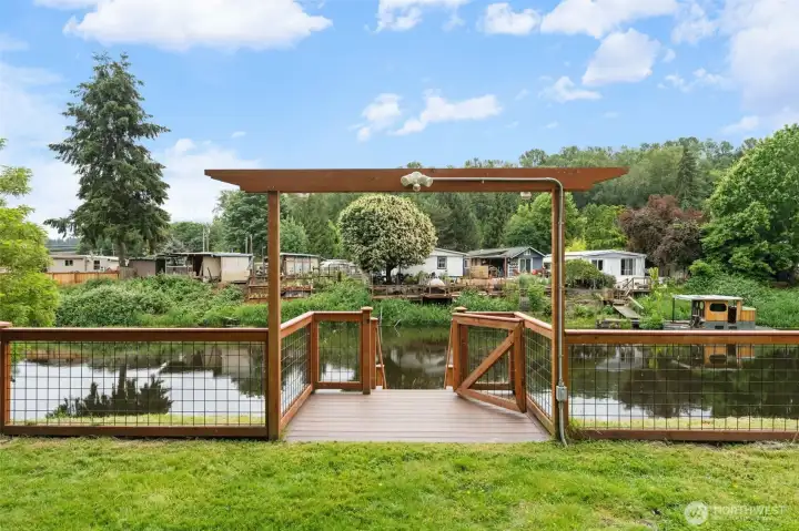 A charming cedar-framed pergola gate opens to your waterfront patio, offering direct access to the water for fishing, kayaking, or simply unwinding at the water's edge. Don't miss the beautifully landscaped surroundings — this is a rare amenity that sets this property apart.