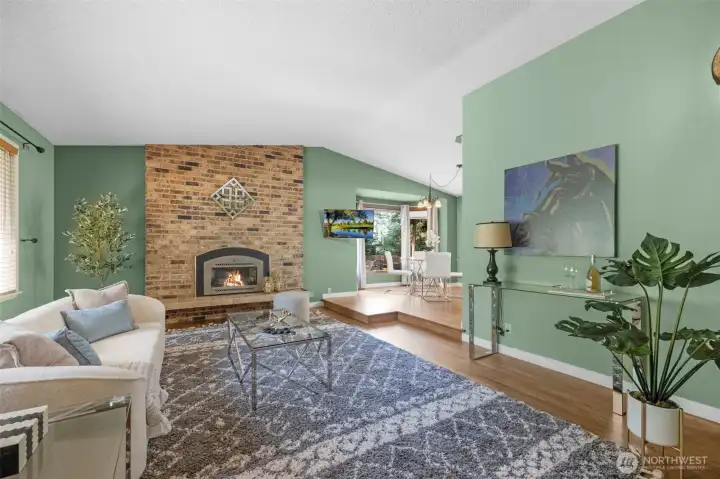 Living room with gas fireplace and adjacent dining room.