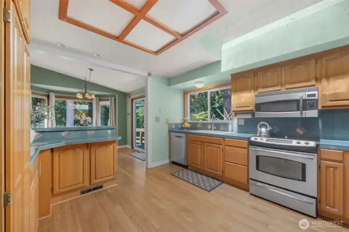 Looking northwest into kitchen and dining area.
