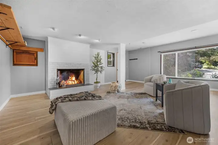 lower level family room with fireplace. Access to side of house on eastside of the home.