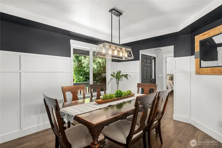 Wall design and new light fixture lends the dining room a modern feel. Wall design and new light fixture lends the dining room a modern feel.
