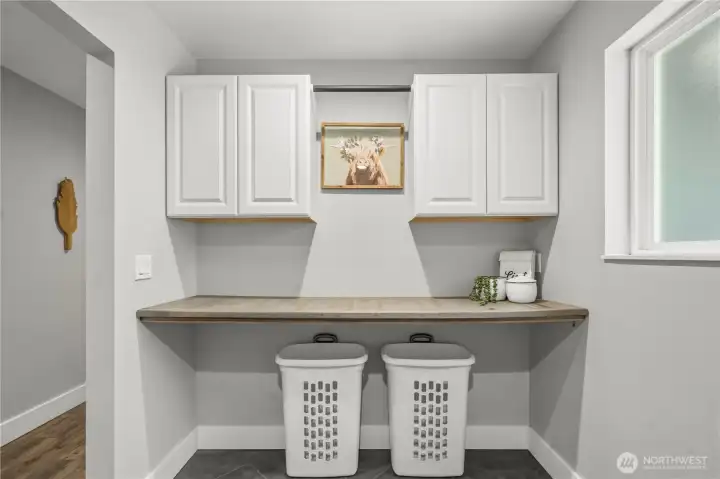 Upstairs laundry room cabinets, counter and sorting area. Allows for hang drying, folding and supplies. Upstairs laundry room cabinets, counter and sorting area. Allows for hang drying, folding and supplies.