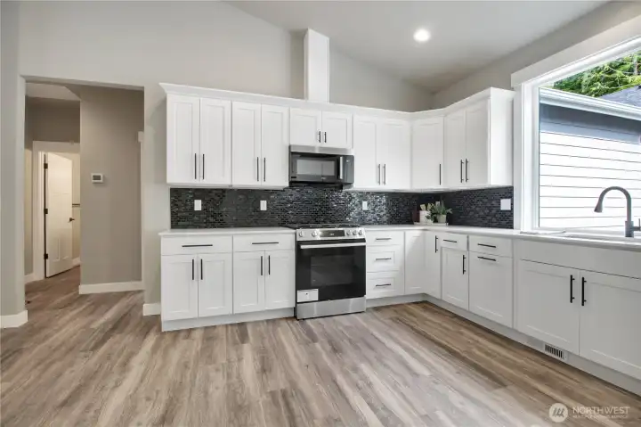 To the left side is the entry into the shared bathroom, 2 bedrooms, and utility room to the garage To the left side is the entry into the shared bathroom, 2 bedrooms, and utility room to the garage