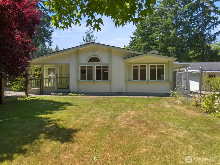View of the home from inside the fenced yard.