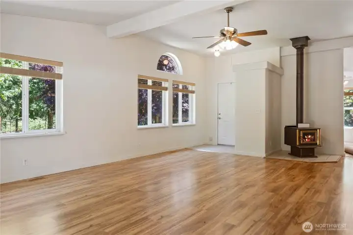 Great room looking to the entry and the wood stove (has not been used and is up to buyer to verify)