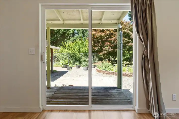 Slider to take you to the covered patio with garden space that is fullly fenced.