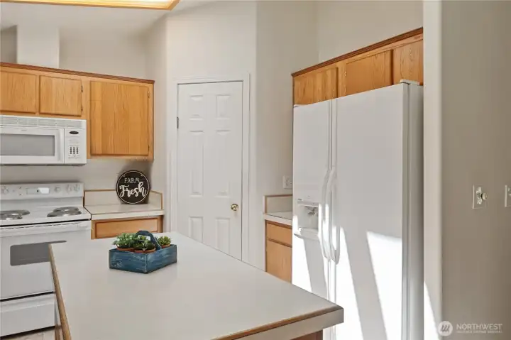 Kitchen with island and walk-in pantry.