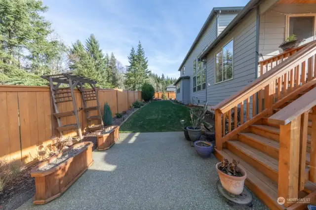 Experience the joy of gardening in this lovingly tended backyard.