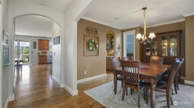 A spacious dining area with a seamless sightline into the modern kitchen.