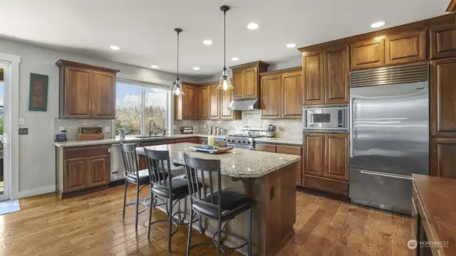 A beautifully designed kitchen with a tiled island and stylish seating for casual dining.