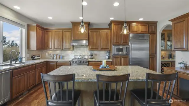 Rustic wood cabinetry enhances this spacious kitchen, making it a dream for any home chef.