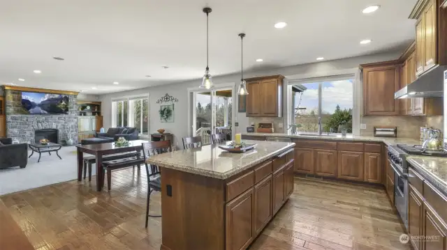 Open-concept kitchen and great room with a fireplace and TV—ideal for entertaining.