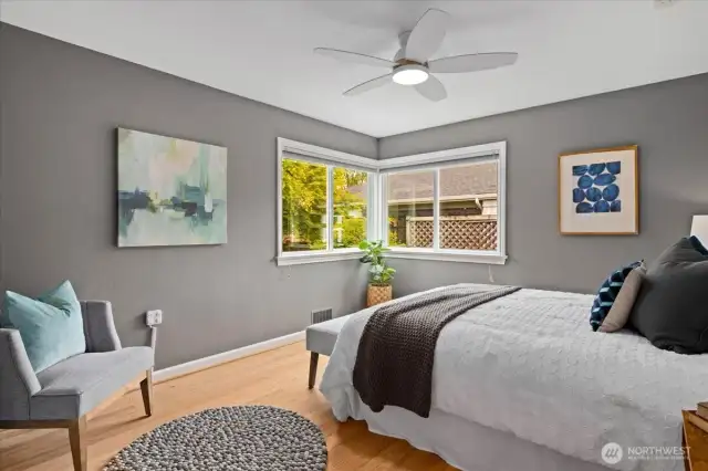 A soft, modern palette in the second bedroom and dual corner windows create a serene space to unwind.