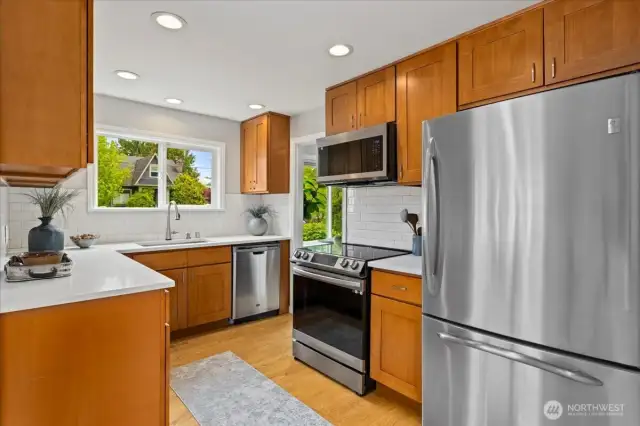 Stainless steel appliances, abundant storage, and dual windows make this kitchen as functional as it is stylish.