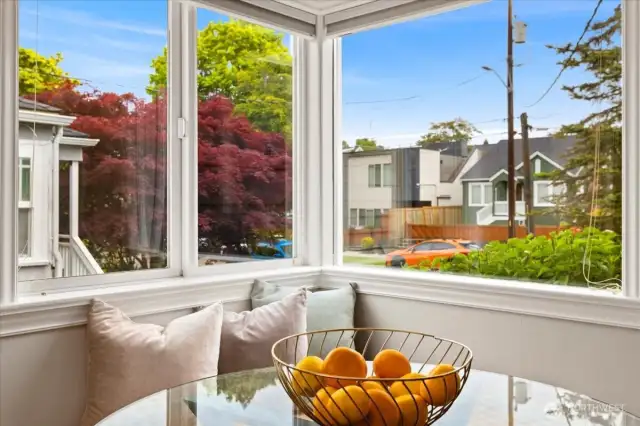 A cozy corner bench invites you to start your day with sunshine, vibrant foliage, and neighborhood charm.