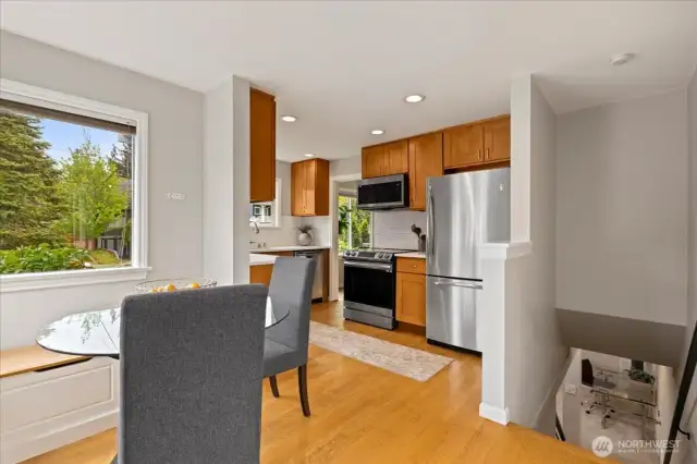 Enjoy casual meals in the cozy breakfast nook, with views to the garden and access to the lower level.