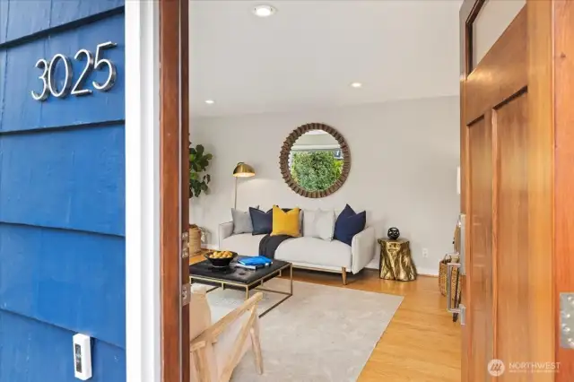 Step through the solid wood door into a bright and inviting living space with timeless style.