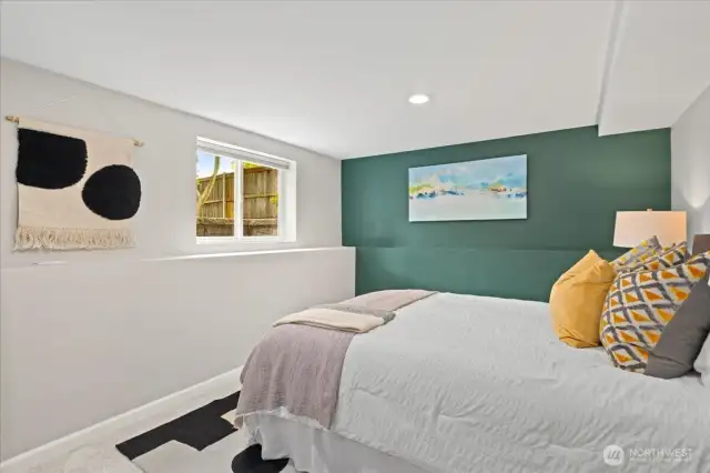 Bright and surprisingly spacious, this downstairs bedroom easily accommodates a full furniture setup with room to spare.