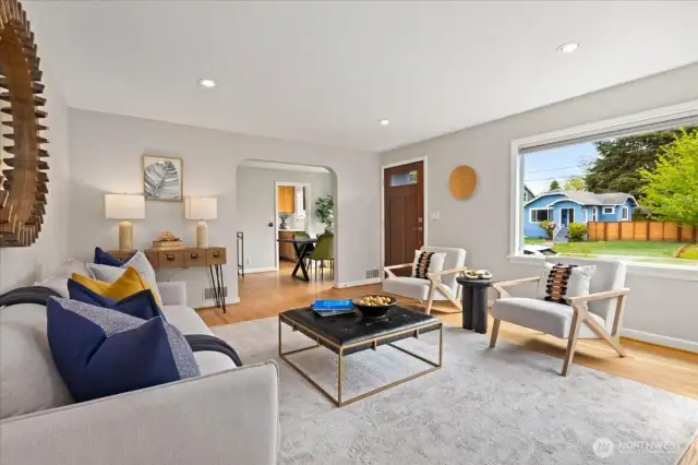 The living area seamlessly connects to the dining room, offering views to both the front and side yard.
