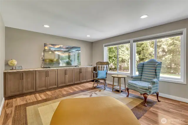 The family room comes equipped with a row of built-ins and windows that overlook the backyard.