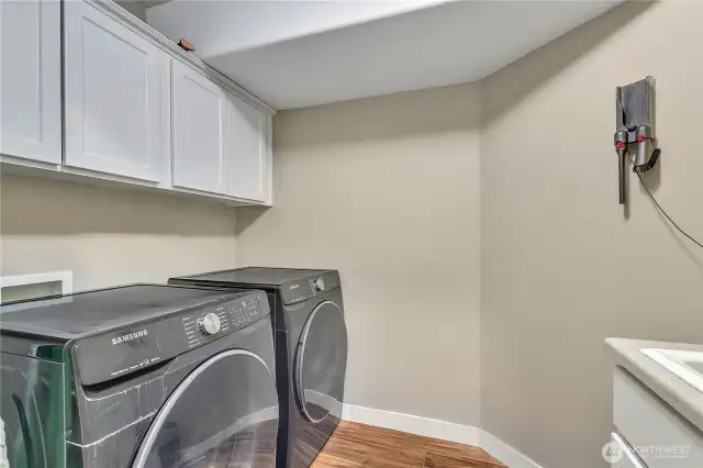 Laundry room with convenient sink and built-ins for your storage needs.