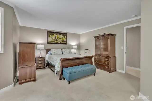 Spacious primary bedroom offers respite at the end of the day.