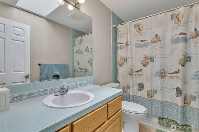 Full bath with tub/shower combo.