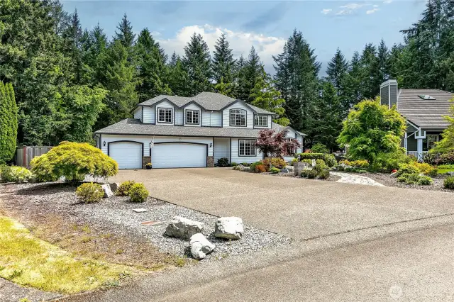Front exterior view. The 3-car garage features new epoxy flooring. To the left of the garage is space for RV parking.
