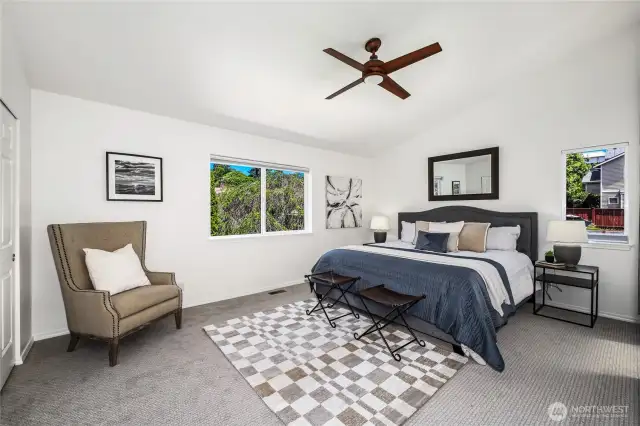 Grand primary bedroom with vaulted ceilings.