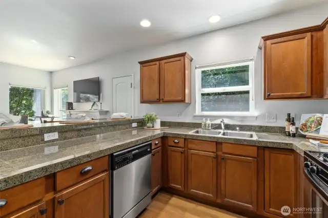 The kitchen has stone countertops and newer SS appliances.