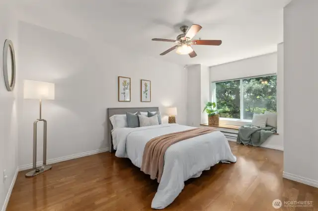 The spacious primary bedroom is both private and sun-filled.