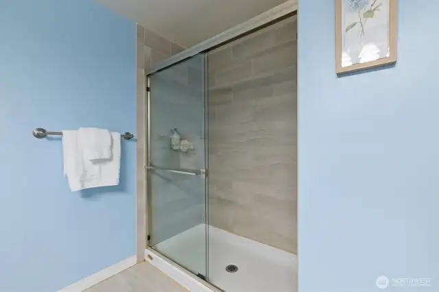 Large walk-in shower located in the primary bthroom.