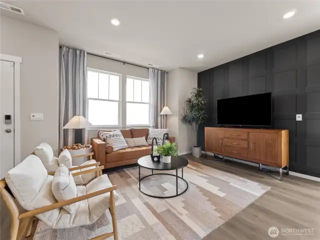 Light-filled great room showcases designer accent wall, recessed lighting and oversized windows for relaxed gatherings. Pictures are for representational purposes only, colors and features may vary.