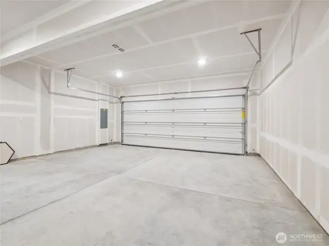 11: Spacious two-car alley-load garage is fully drywalled and brightly lit—ready for parking, storage, or workshop projects. Pictures are for representational purposes only, colors and features may vary.