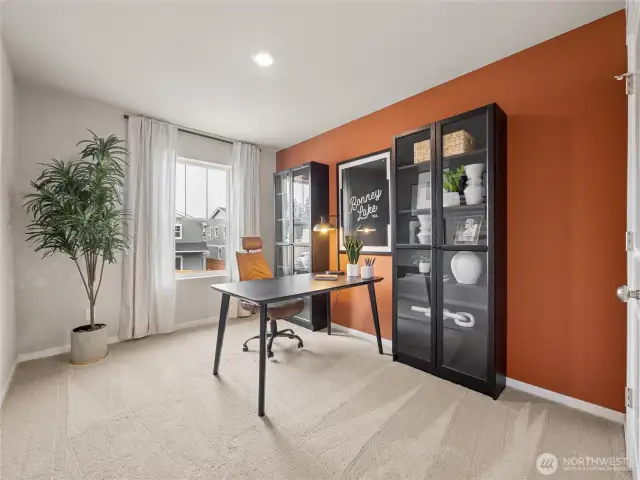 Flexible bedroom easily converts to a home office, highlighted by a vibrant accent wall, display cabinets, and serene window view. Pictures are for representational purposes only, colors and features may vary.