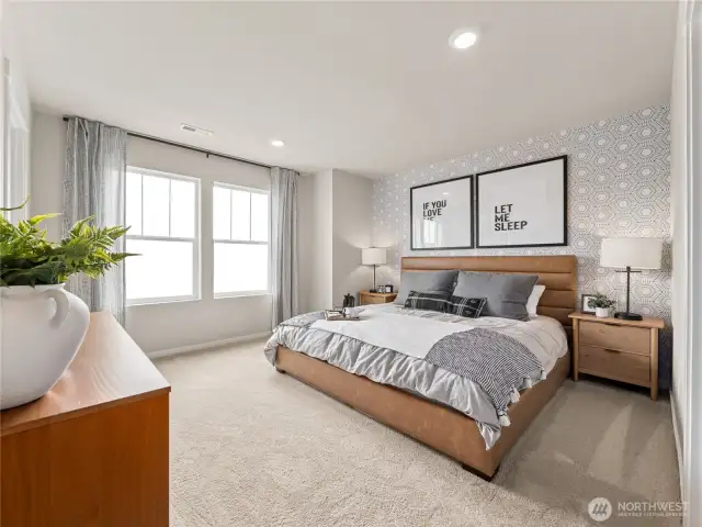 Primary suite delivers king-size comfort with patterned feature wall, twin windows, and soft neutral décor for a calming oasis. Pictures are for representational purposes only, colors and features may vary.