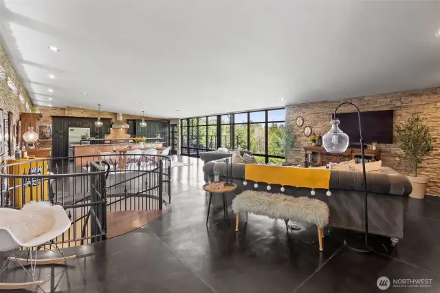 Beautiful open space design with lots of windows and light. Notice the beautiful floors and copper accents, lots of stone on the wall.
