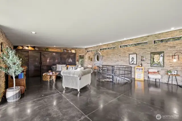 From dining area looking towards living rm. Custom shelving unit at the end of the room with antiqued metal doors