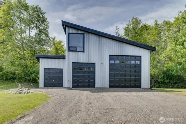 Detached shop with 3 bays, and studio or bedroom space above.