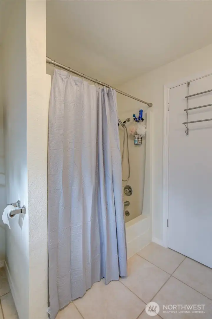 Shower/tub in upstairs bathroom.