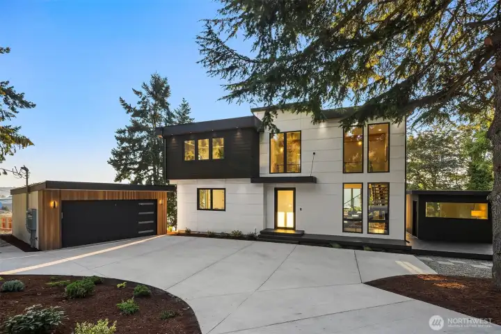 Modern curb appeal – A bold façade with sleek lines, circular driveway, and striking architecture that makes a lasting first impression.