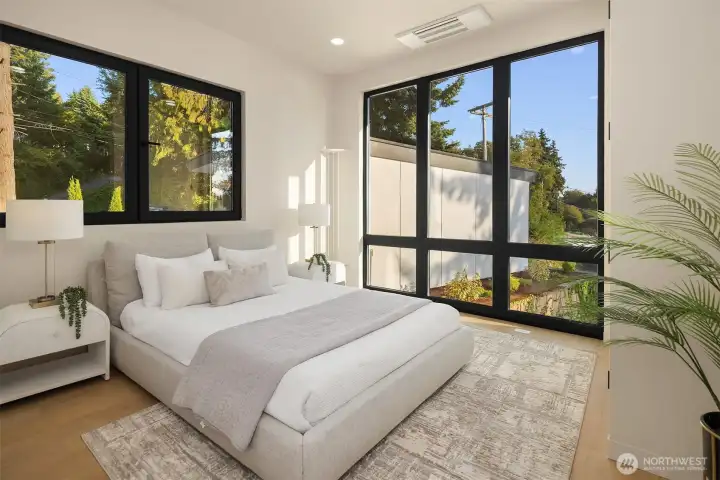 Main floor Peaceful retreat – Sun-filled bedroom with modern lines and restful energy.