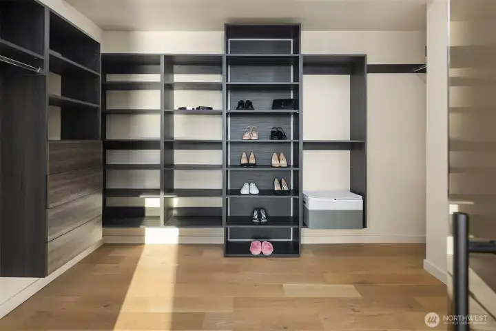 Custom storage – Expansive walk-in closet with sleek modern built-ins.